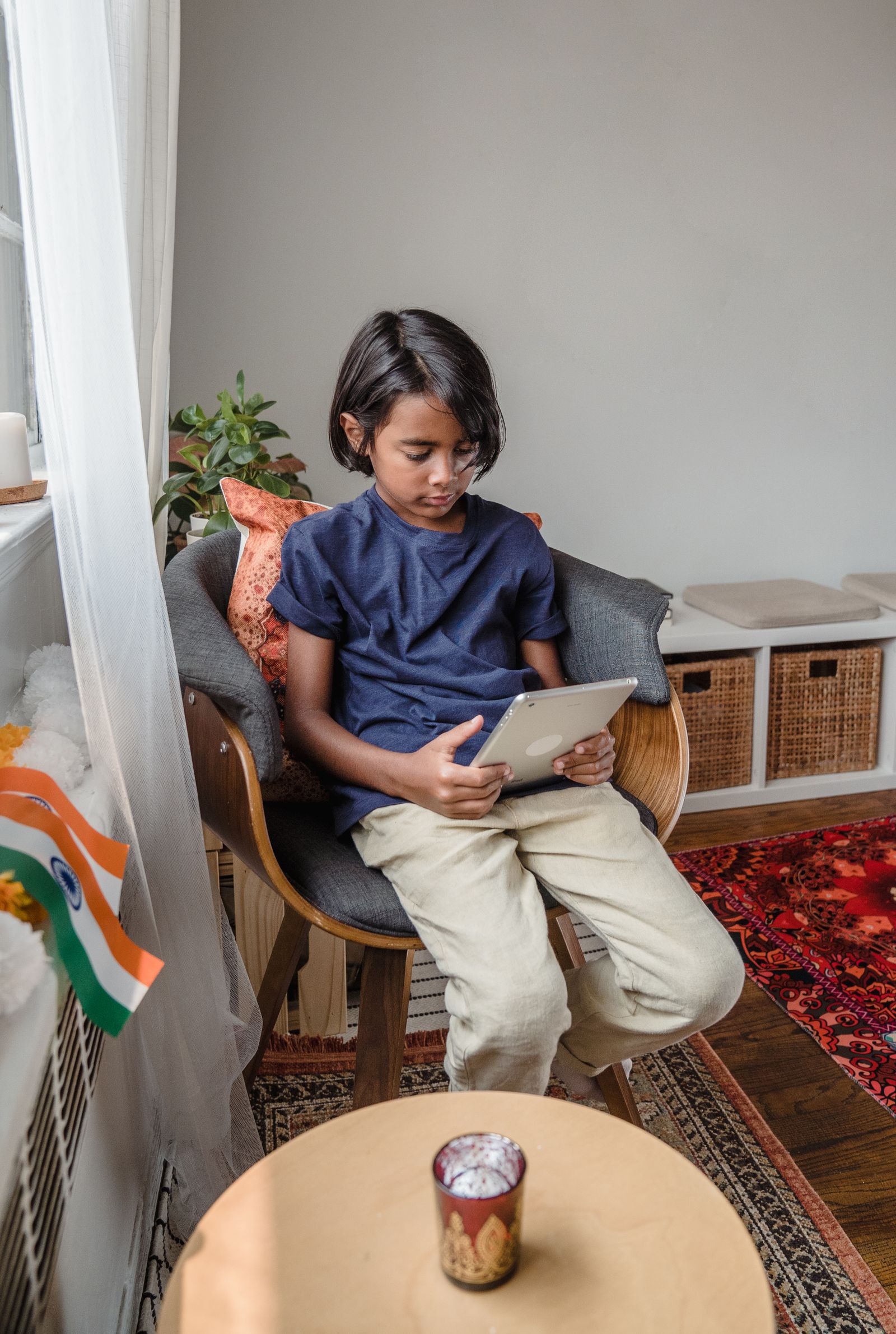 A boy reading a story on a tablet at home